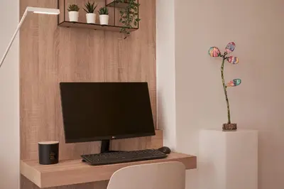 a computer monitor and keyboard on a wooden desk at Charitos Heights Boutique Apt II, Kolonaki in Athens