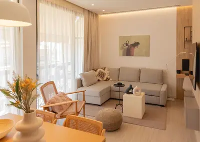 a living room with a couch and a table at Charitos Heights Boutique Apt II, Kolonaki in Athens