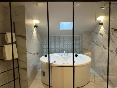 a bathroom with a white tub and a sink at Belle Athenes - Luxury Rooms at Monastiraki Railway Station in Athens