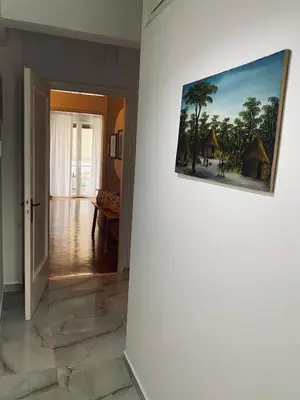 a hallway with a painting on a wall at Athens Sunnyside condo in Athens