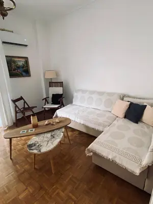 a living room with a couch and a coffee table at Athens Sunnyside condo in Athens