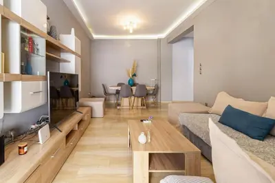 a living room with a couch and a table at Urban grey in Athens