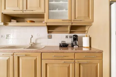 a kitchen with wooden cabinets and a sink at Urban grey in Athens