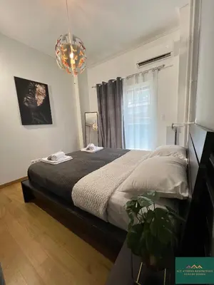 a bedroom with a bed and a window at Thiseio Residence 58 in Athens