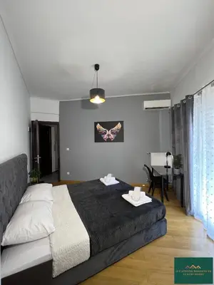a bedroom with a bed and a table in it at Thiseio Residence 58 in Athens