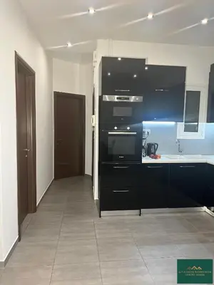 a kitchen with black cabinets and a counter top at Thiseio Residence 58 in Athens