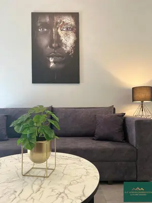 a living room with a couch and a table at Thiseio Residence 58 in Athens