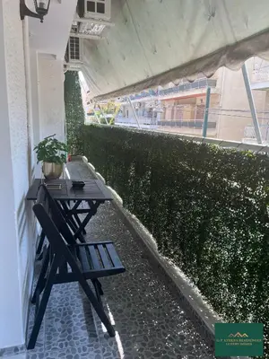 a picnic table on a balcony with a plant at Thiseio Residence 58 in Athens