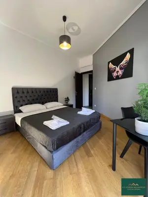 a bedroom with a bed and a table and a butterfly picture at Thiseio Residence 58 in Athens