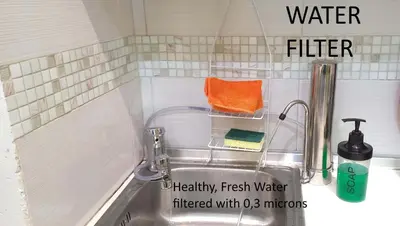 a kitchen sink with a faucet and an orange towel at Smart apartment, Athens. in Athens