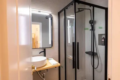 a bathroom with a sink and a shower at Eden - A Night near Athens Int Arpt in Spáta