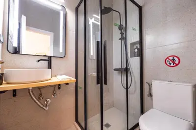 a bathroom with a shower and a toilet and a sink at Eden - A Night near Athens Int Arpt in Spáta