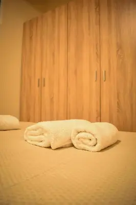 a stack of towels sitting on a bed at Όμορφο διαμέρισμα στην περιοχή της Ηλιούπολης in Athens