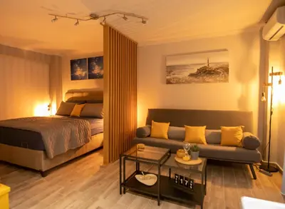 a living room with a bed and a couch at Hesperides Garden in Athens