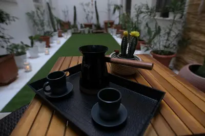 a black tray with cups and a vase on a table at Hesperides Garden in Athens