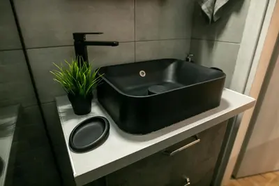a black sink on a counter in a bathroom at Hesperides Garden in Athens