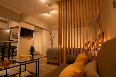 a living room with a couch and a bed at Hesperides Garden in Athens