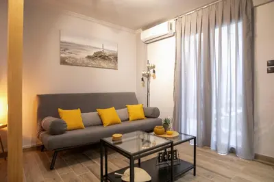 a living room with a couch and a table at Hesperides Garden in Athens