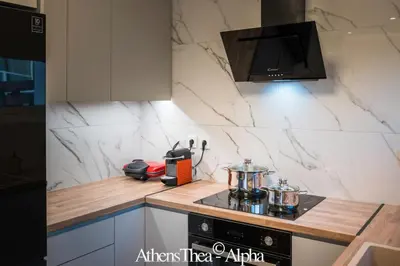 a kitchen with white marble walls and a counter top at AthensThea Alpha Luxury Penthouse Apt in Omonia in Athens