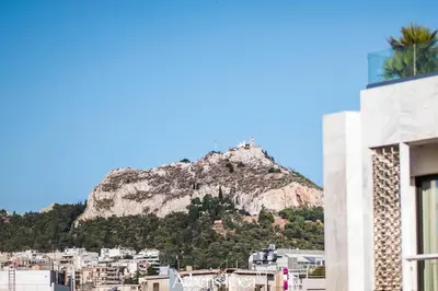 a mountain in the background of a city at AthensThea Alpha Luxury Penthouse Apt in Omonia in Athens