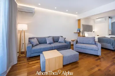 a living room with two blue couches and a table at AthensThea Alpha Luxury Penthouse Apt in Omonia in Athens