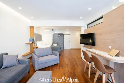 a living room with a couch and a table and chairs at AthensThea Luxury Penthouse Apt in Omonia 115sq.m. in Athens