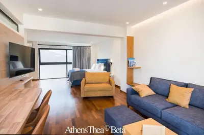 a living room with a couch and a bed at AthensThea Luxury Penthouse Apt in Omonia 115sq.m. in Athens