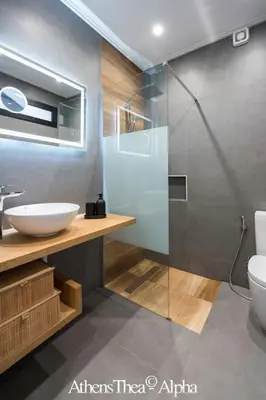a bathroom with a sink and a glass shower at AthensThea Luxury Penthouse Apt in Omonia 115sq.m. in Athens
