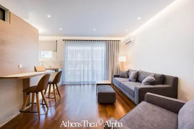 a living room with a couch and a table at AthensThea Luxury Penthouse Apt in Omonia 115sq.m. in Athens