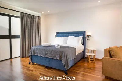 a hotel room with a bed and a couch at AthensThea Luxury Penthouse Apt in Omonia 115sq.m. in Athens