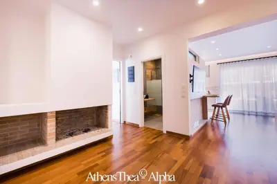 a living room with a fireplace and a table at AthensThea Luxury Penthouse Apt in Omonia 115sq.m. in Athens
