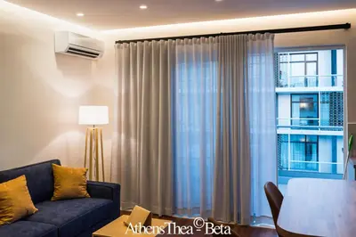 a living room with a couch and a window at AthensThea Luxury Penthouse Apt in Omonia 115sq.m. in Athens