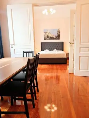 a bedroom with a bed and a table and chairs at Elegant apartment in Syntagma square in Athens