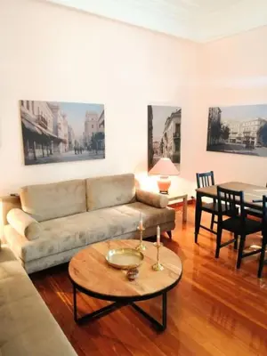 a living room with a couch and a table at Elegant apartment in Syntagma square in Athens