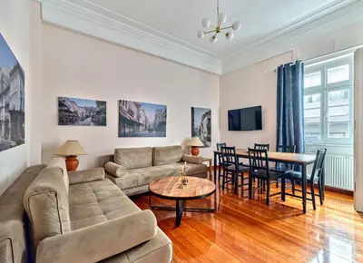 a living room with a couch and a table at Elegant apartment in Syntagma square in Athens