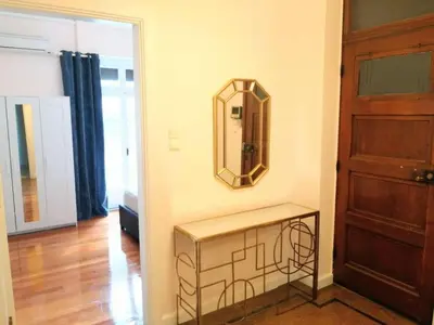 a room with a mirror on the wall next to a door at Elegant apartment in Syntagma square in Athens