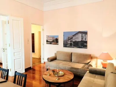 a living room with a couch and a table at Elegant apartment in Syntagma square in Athens