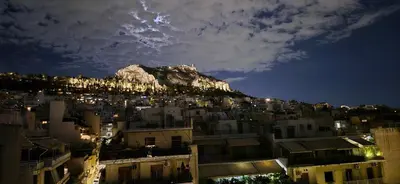 a view of a city at night with a mountain at Lycabettus view apartment in Athens