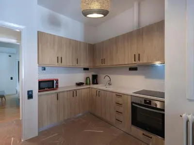 a kitchen with wooden cabinets and a microwave at Lycabettus view apartment in Athens