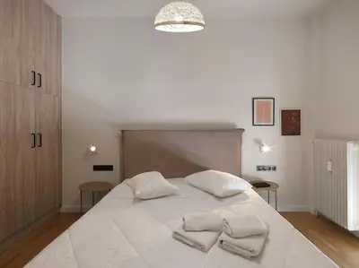 a bedroom with a white bed with two towels on it at Lycabettus view apartment in Athens