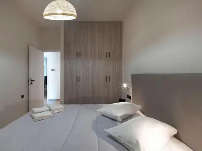 a bedroom with a large white bed with pillows at Lycabettus view apartment in Athens