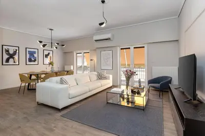 a living room with a white couch and a table at The Beehive Apartments in Athens