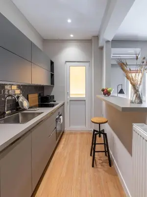a kitchen with a counter and a stool in it at The Beehive Apartments in Athens