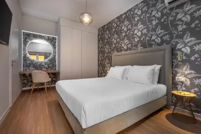 a bedroom with a bed with a black and white wallpaper at The Beehive Apartments in Athens