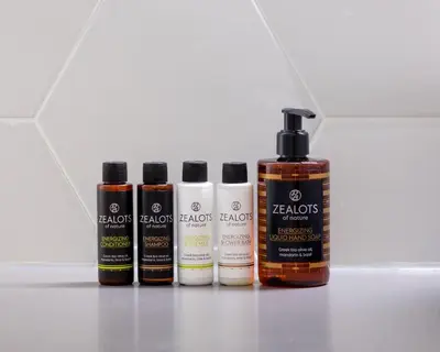 a group of four bottles of hair products on a counter at The Beehive Apartments in Athens