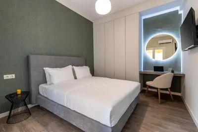 a bedroom with a bed and a mirror at The Beehive Apartments in Athens
