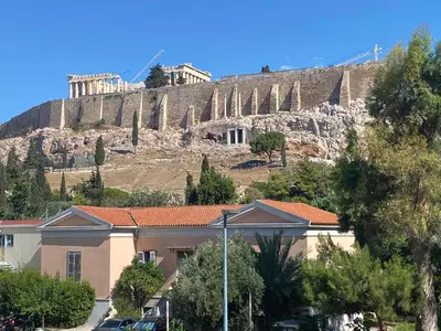 a building in front of a hill with the acropolis at Check Point - Acropolis View B in Athens