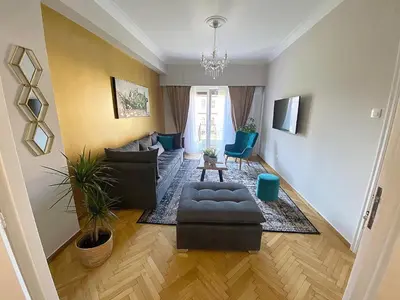 a living room with a couch and a table at Check Point - Acropolis View B in Athens
