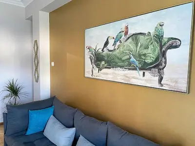 a living room with a couch and a painting on the wall at Check Point - Acropolis View B in Athens