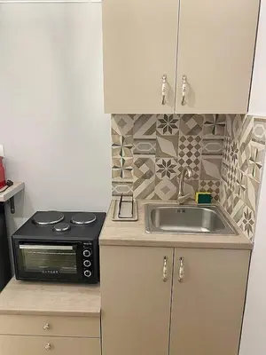 a kitchen with a sink and a microwave at Check Point - Acropolis View B in Athens